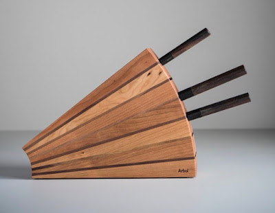 knife block in cherry, with knives in it, held at a 45 degree angle
