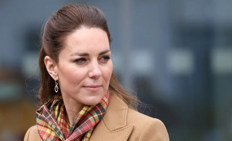 Kate Middleton wore a cashmere coat by Massimo Dutti with a jumper and wide-leg trousers. Hamilton and Inches earrings