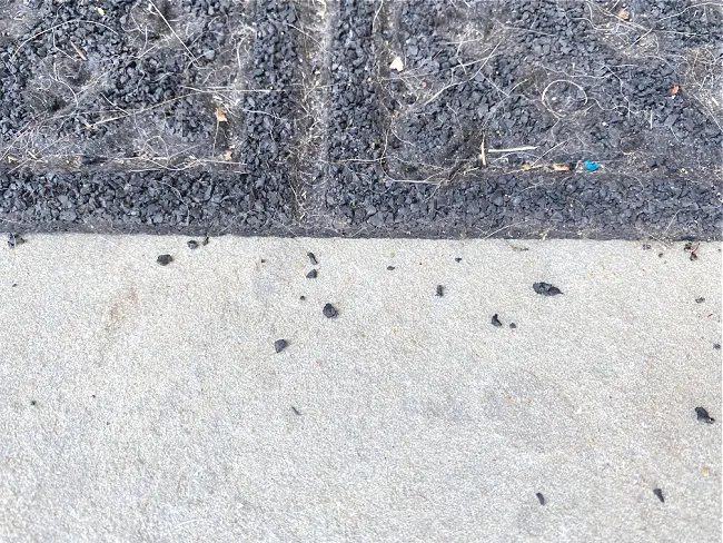 black pieces falling off mat