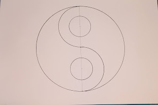 this is an A4 paper on which is traced a yin yang symbol