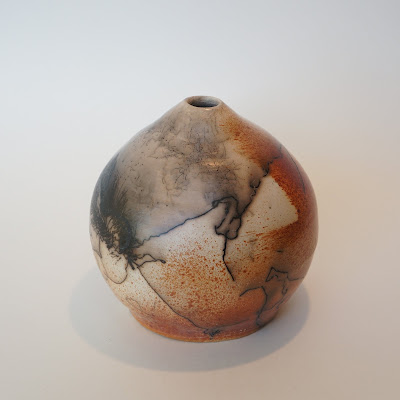 Beautiful horsehair and feather raku pottery vase by Lily.