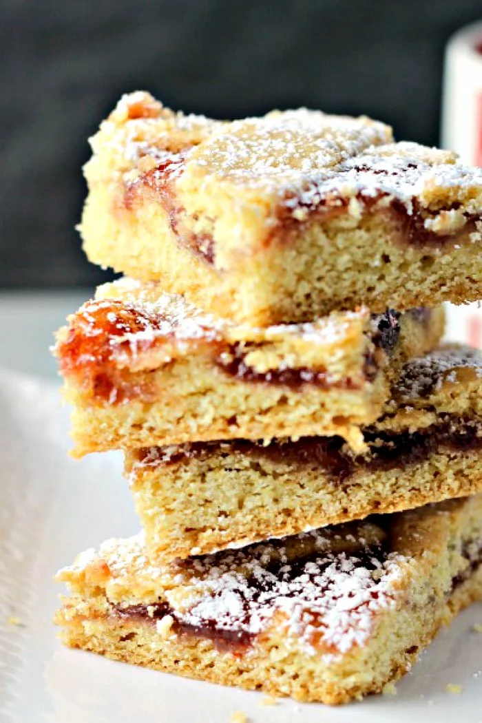 Mom's Strawberry Squares by Renee's Kitchen Adventures stacked on a white plate