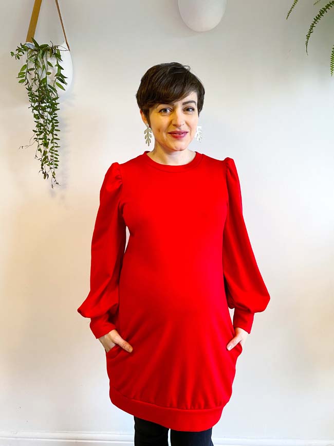 Red Billie sweatshirt dress with bishop sleeves, worn by Tilly