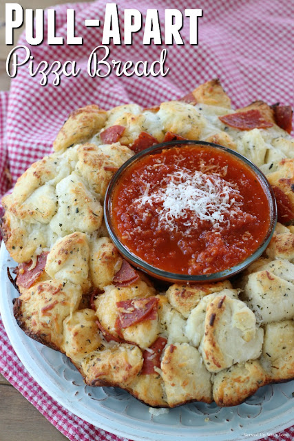 biscuits, pepperonis and cheese baked together in a bundt pan to make a ring with pizza sauce in the middle