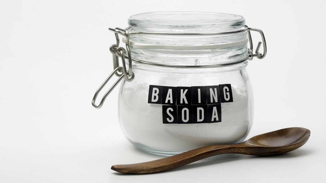 Jar of baking soda on the white background.