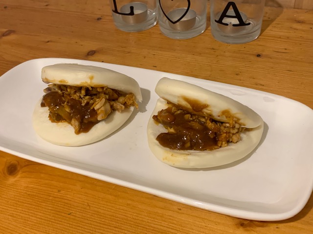 Two orean chicken bao buns with kimchi slaw on a platter