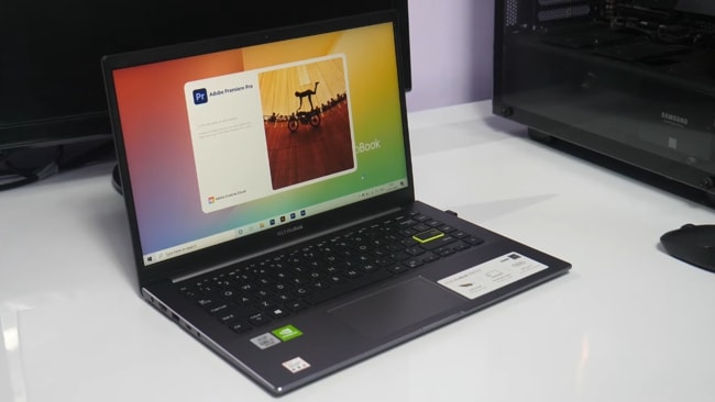 Asus VivoBook S14 S433FL laptop with matte grey finish and green-colored highlighted enter-key.