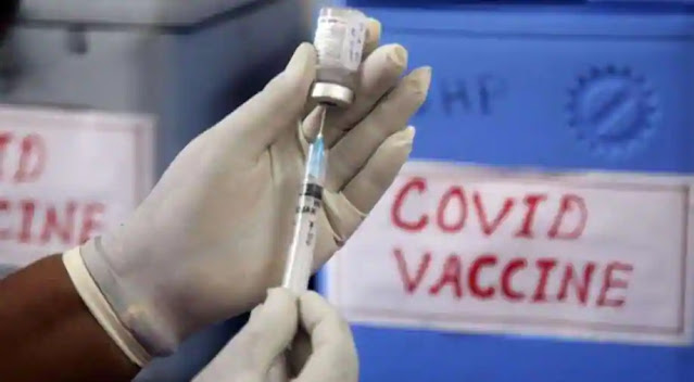 A Doctor Holding a Coronavirus Vaccine and injection