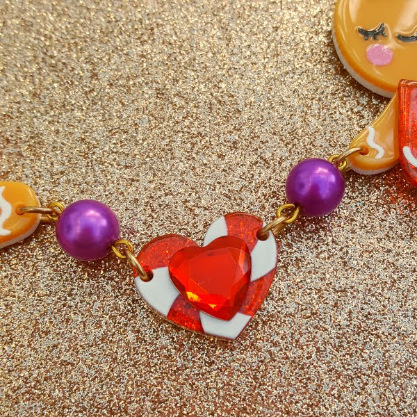 candy swirl and jewel red heart on festive necklace