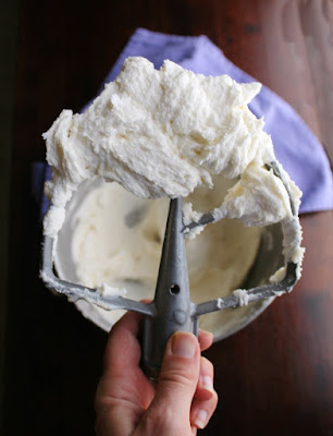 All of the tangy cream cheese flavor you love in the classic frosting, but sturdy enough to be piped and hold it's shape. This decorator's cream cheese frosting is the best parts of buttercream and cream cheese frosting combined. mixer paddle full of decorator's cream cheese frosting
