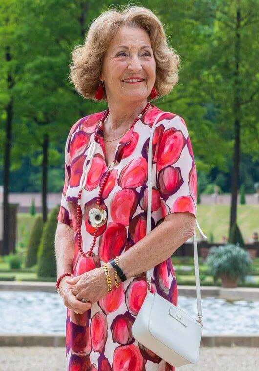 Princess Margriet wore a red floral print dress and red pumps, carried white bag