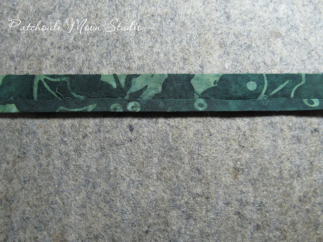 Patchouli Moon Studio~ Fabric Container to Hold Crafter's Edge Die Cuts & Plates fabric strip showing how fabric stems for flowers are made