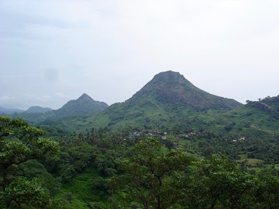 "Mount Abu beckoning tourists, with its mantle of green hues."