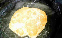 Puffy and fluffy golden brown bhature over hot oil
