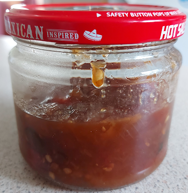 Small half-filled salsa jar