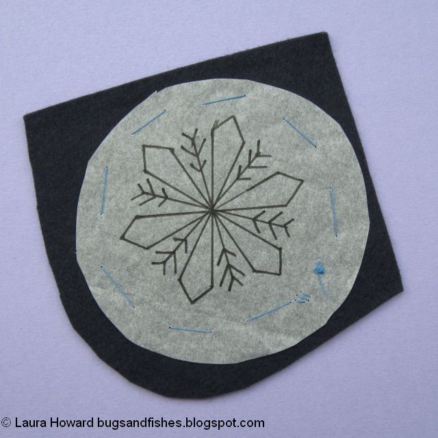 secure the snowflake embroidery pattern to the felt