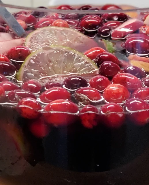 closeup of cranberries and lime in glass bowl