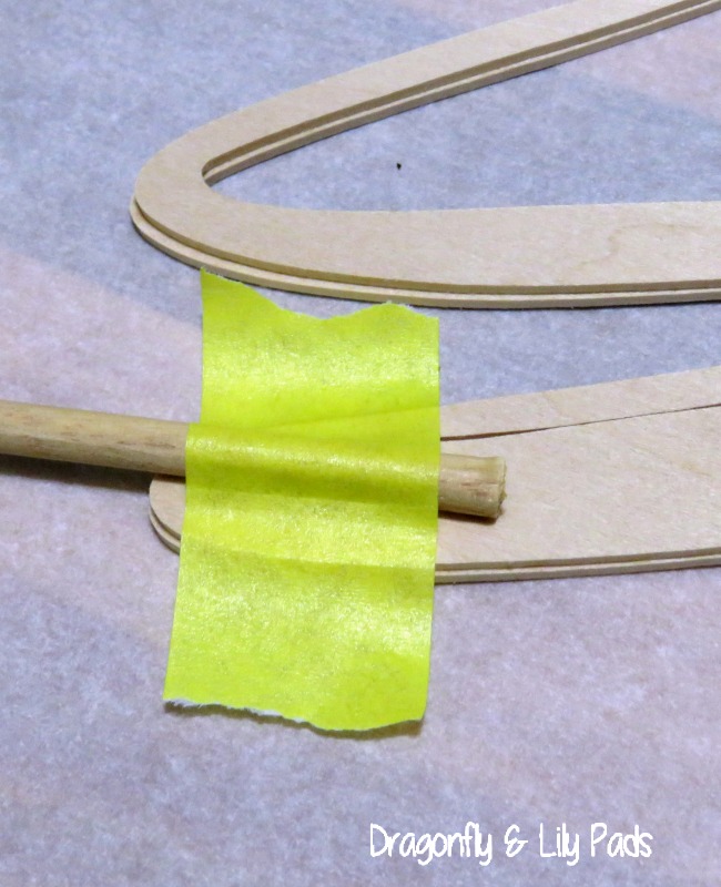 Use masking tape to hold the stick to the back of your Initial as the glue dries.