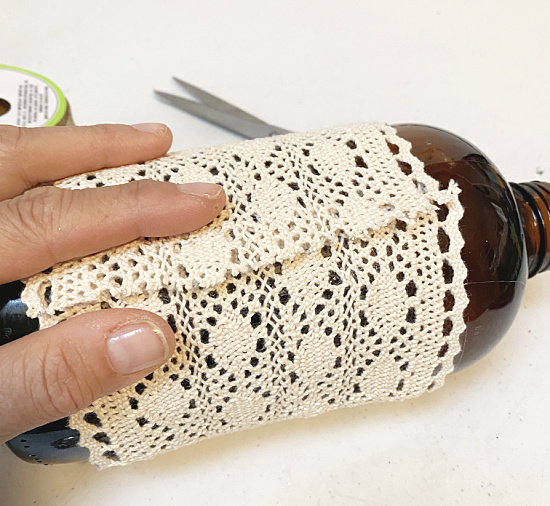 wrapping wide cotton lace around the bottle