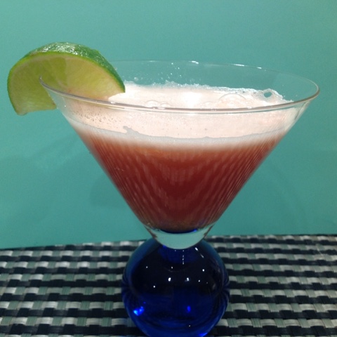 watermelon limeade drink with a wedge of lime