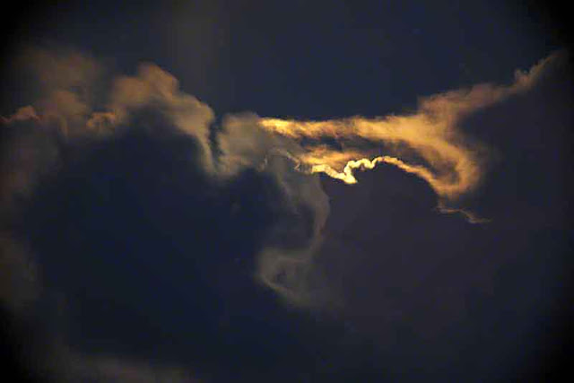 Clouds in night sky as moon rises