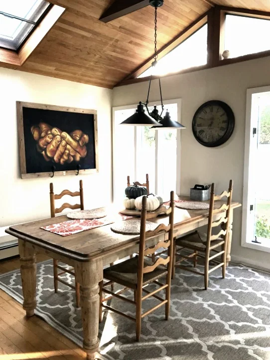 dining table with picture and ceiling chandelier