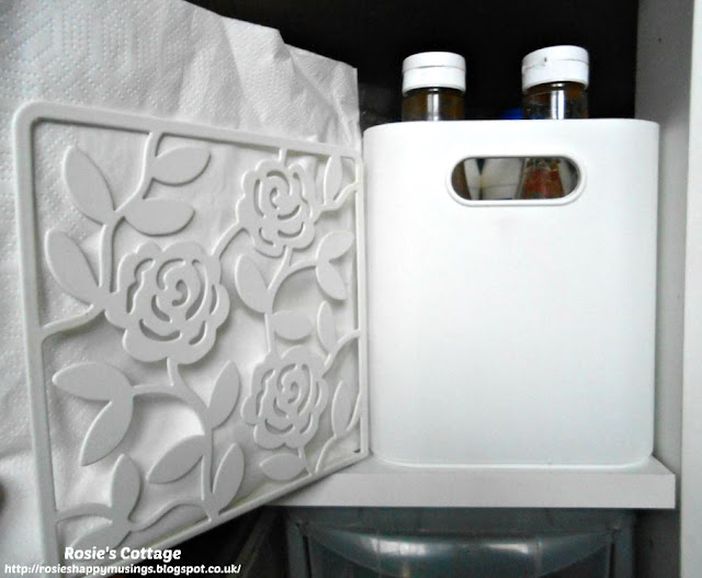 Kitchen Cabinet Re-Organisation: To the front of this shelf I added two easily grab-able containers.  One has baking supplies and the other has our condiments like salt, pepper and sauces. Between these containers is a napkin holder with our last ever paper napkins!