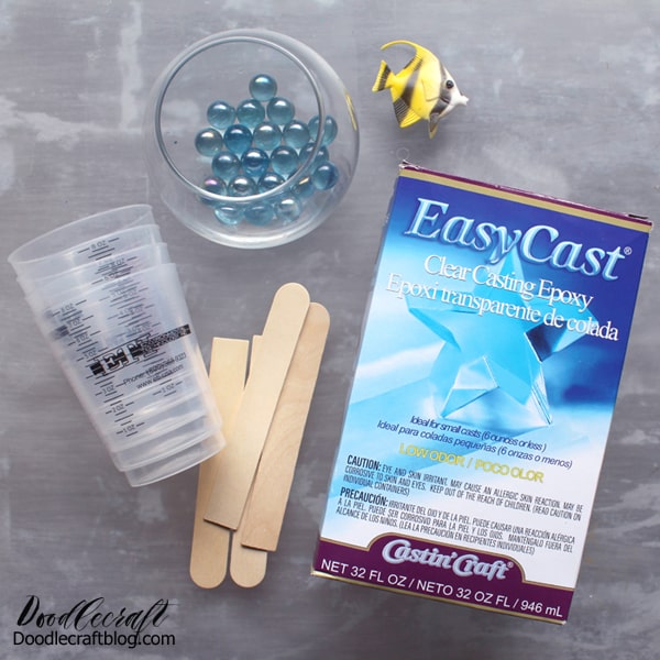 SUPPLIES NEEDED: EasyCast Clear Casting Epoxy  Small round bowl  Handful of Marbles  Plastic Fish  Stirring Sticks, Mixing Cups, Disposable Gloves and Work Surface  Straw or Heat Gun