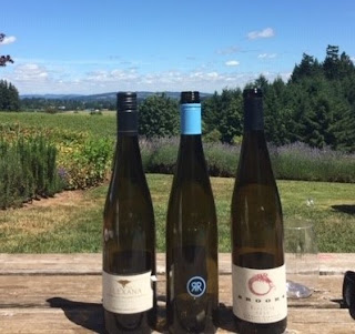 three Oregon Riesling wine bottles outdoors