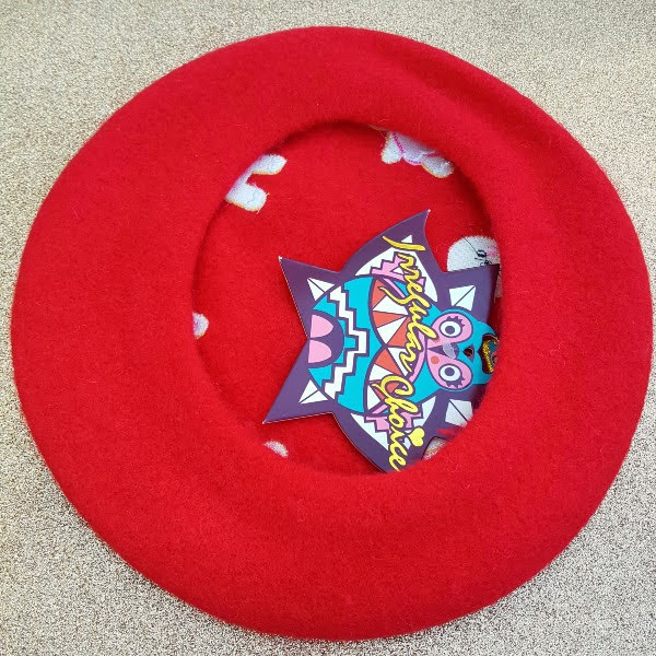 back of red wool beret with Irregular Choice tag