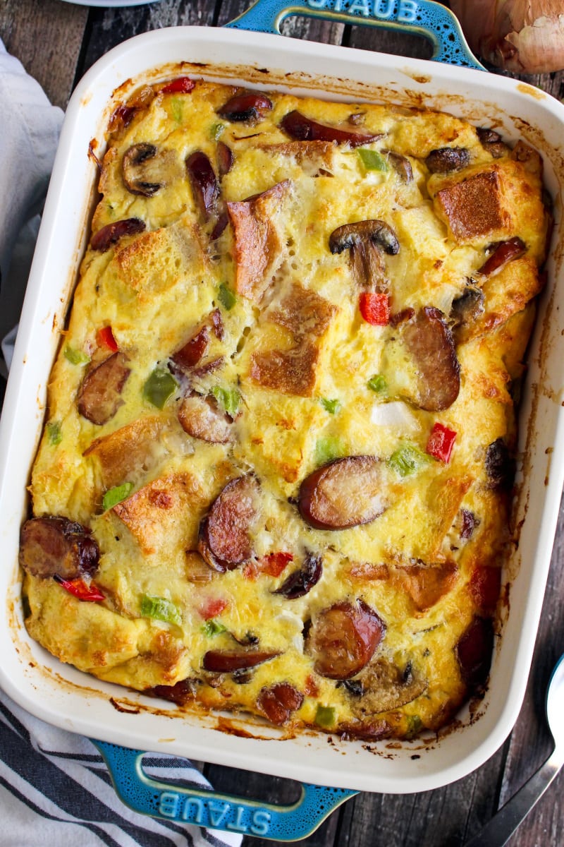 Top view of Bratwurst and Cheddar Breakfast Casserole in a casserole dish on a rustic wood background.