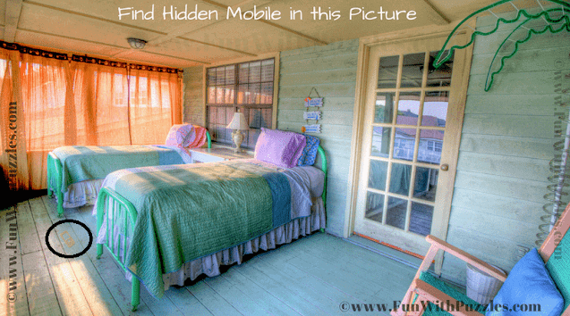 This mobile is lying on the floor between two beds.