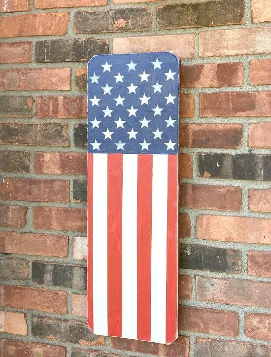 Wooden American flag on a brick wall