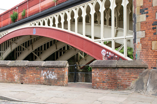 Painted metal bridge with gap in wall