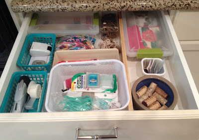 kitchen drawer holding miscellaneous things in various containers