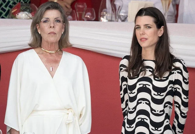 Princess Caroline wore a new wide short sleeve wrap front jumpsuit from Halston. Charlotte Casiraghi wore a new silk crepe dress from Chanel