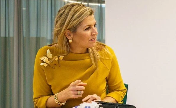 Queen Maxima wore a tartan mohair coat by Natan, and yellow stretch wool crepe top and trousers by same brand. Celedonio gold dragonfly brooch