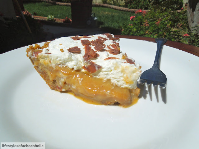 banoffee pie with a fork on a white plate outside