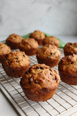 These chocolate chip sourdough muffins are a delicious and nutritious way to start your day! They are quick, easy and full of oatmeal and whole wheat goodness yet they are soft and yummy. So good! cooling rack full of chocolate chip oat sourdough muffins