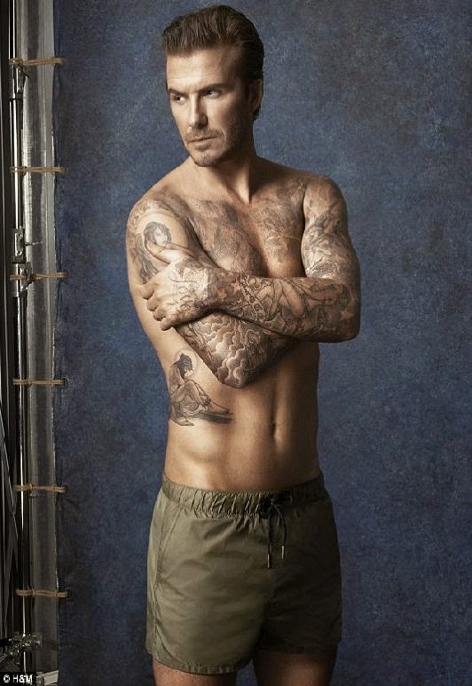 David Beckham displays his buff body and tattooed torso as he