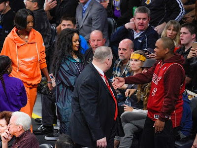 Rihanna being introduced to some guest at Jan. 2015 Lakers Game,