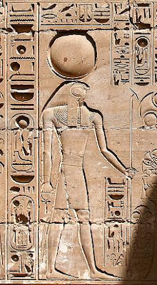 Khonsu, wearing the lunar crescent with the moon disc, and holding the ankh and uas scepter