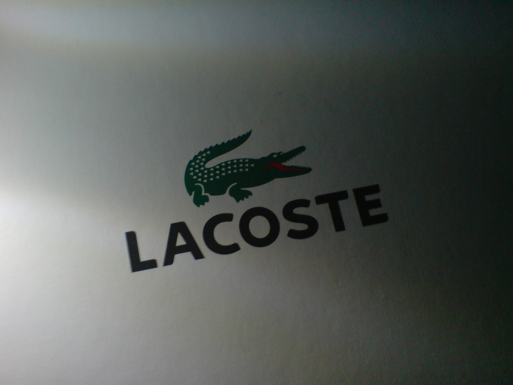 Лакост краснодар. Lacoste логотип 1933. Значок бренда лакост. Фирменный знак лакоста. Лакост символ.