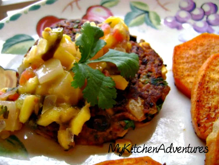 Chipotle Black Bean Burgers with Corn on plate topped with mango salsa