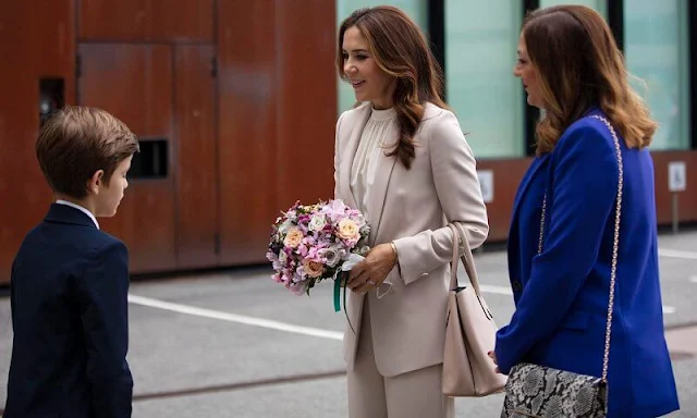 Crown Princess Mary wore a cecel SP blazer and Gytta trousers from Andiata. She carried Prada saffiano cuir double bag