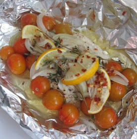 Baked flounder packets with cherry tomatoes, onion, and lemon