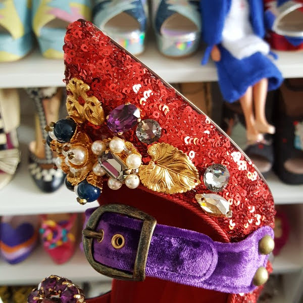 close up of pearls and jewels on toe of red sequins shoes