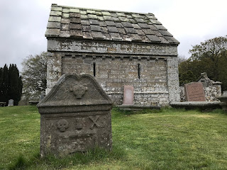 Old gravestone in Kirkgate Cemetery, Kinross with the Bruce Mortuary Chapel behind it.  Photograph by Kevin Nosferatu for The Skulferatu Project.