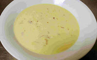 Thicken milk (rabdi) with chopped nuts and pistachios