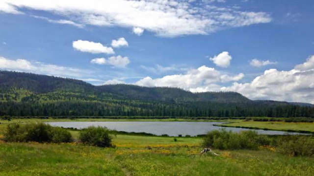 Mountain range beside lake